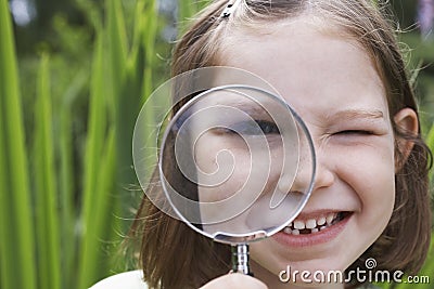 Closeup Of Girl Looking Through Magnifying Glass