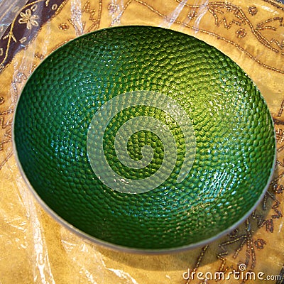 Closeup of a green metal dish, fair trade products in India