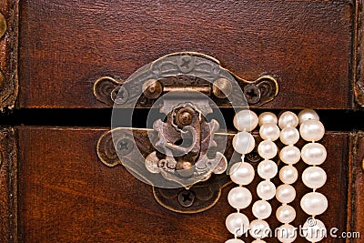 Closeup jewellery box latch and pearls