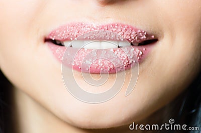 Closeup on lips of young woman in sugar pleasantly softly smiling white teeth