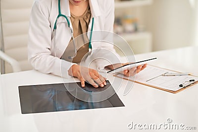 Closeup on medical doctor woman using tablet pc