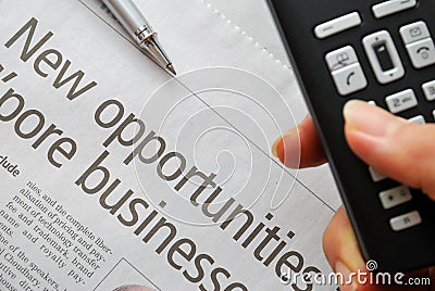 Closeup on new opportunities text and hand phone