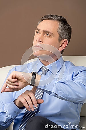 Closeup of older man looking at watch.