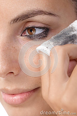 Closeup photo of removing eye makeup