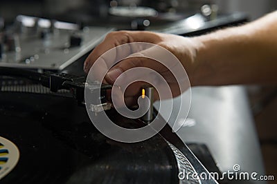 Closeup portrait of dj hands on equipment deck and