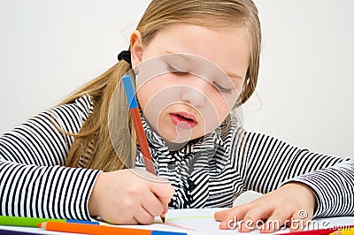 Portrait of girl drawing with colorful pencils