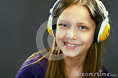 Closeup portrait of a smiling teen girl with headphones