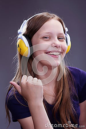 Closeup portrait of a smiling teen girl with headphones