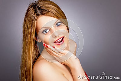 Closeup portrait of surprised beautiful girl holding hand on her