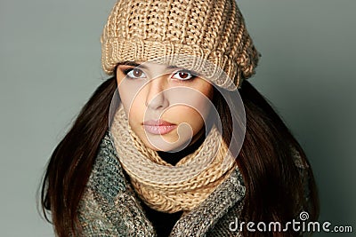 Closeup portrait of a young thoughtful woman in warm winter outfit