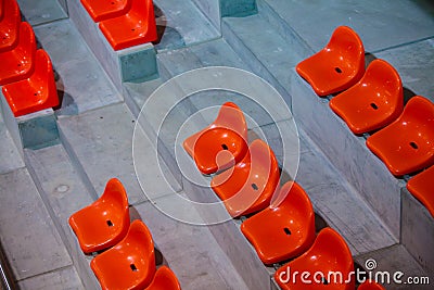 Closeup of red sport stadium seats. Empty stand. Team sport supporter