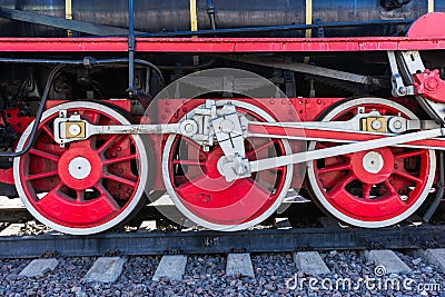 Closeup view of steam locomotive wheels, drives, rods, links and