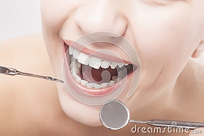 Closeup of Woman Teeth with Dental tools