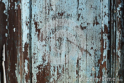 Closeup of a Wooden Door with Peeling Blue/Teal Paint