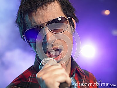 Closeup Of Young Man Singing Into Microphone