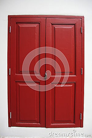 Closing red wooden window vintage style by iron lock