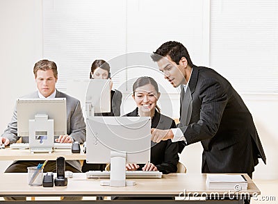 Co-worker Listening To Supervisor Explain Pro