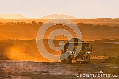 Coal mining truck in orange morning light