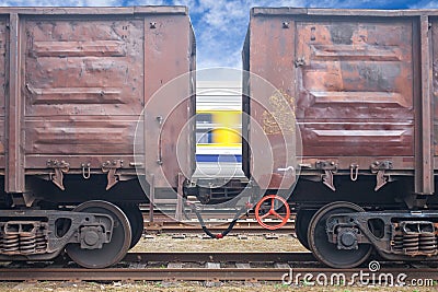 Coal railroad cars and speed train in motion.