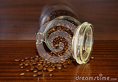 Coffee beans spilling out of a cristal jar