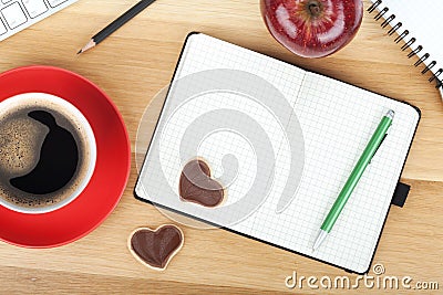 Coffee cup, cookies, red apple and office supplies