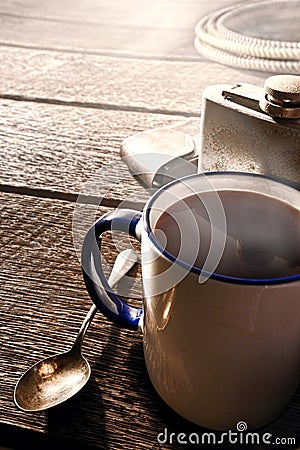 Coffee Cup and Flask with Cowboy Gear in a Ranch