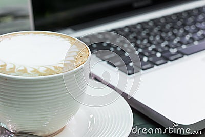 Coffee cup and laptop business