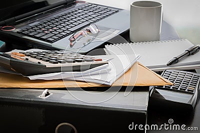 Coffee cup, laptop, Document file , pen , Calculator , notepad a