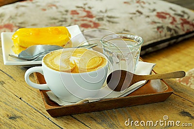 Coffee set with orange cake on wooden table