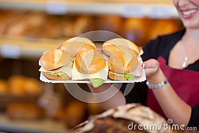 Coffee Shop Worker Holding Tray Full Of Burgers