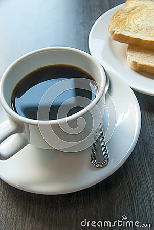 Coffee and toast on wooden table