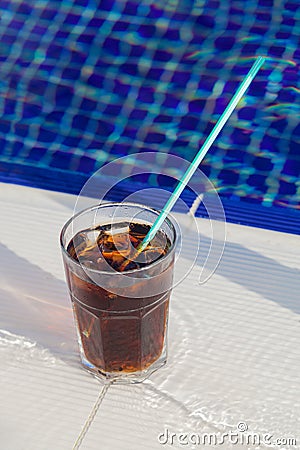 Cold beverage on the edge of swimming pool