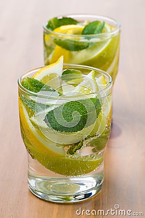 Cold fresh lemonade with lemon, lime and mint