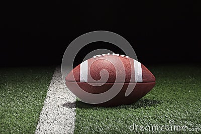 College style football on grass field and stripe at night