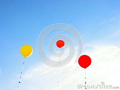 Colorful balloons flying in blue sky