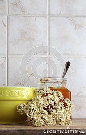 Colorful ceramic cup and jar of jam