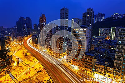 Colorful city night with lights of cars motion blurred in hong k