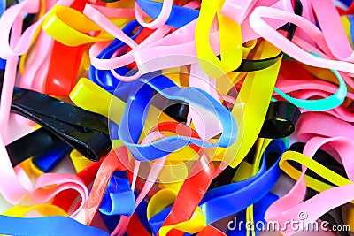 Colorful elastic rubber bands on white texture background