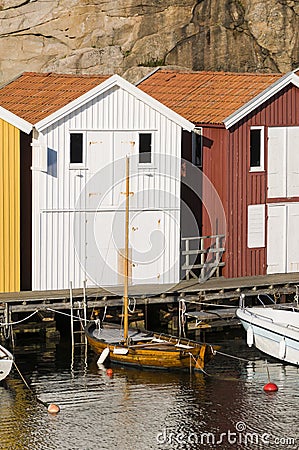 Colorful fishing sheds and wooden boat