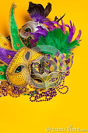 Colorful group of Mardi Gras or venetian mask on yellow