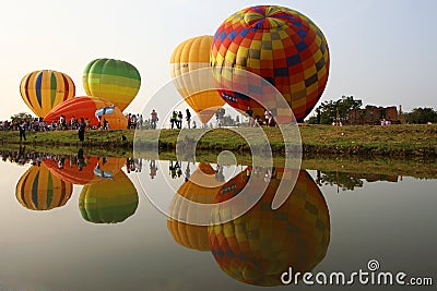Colorful hot air balloons reflected in the water