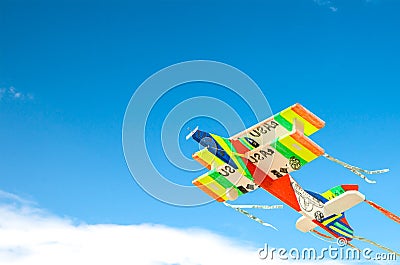 Colorful toy plane over blue sky.