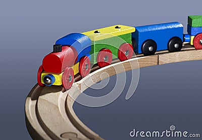 Colorful wooden toy train on tracks