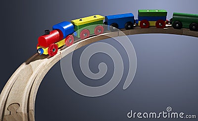 Colorful wooden toy train on tracks