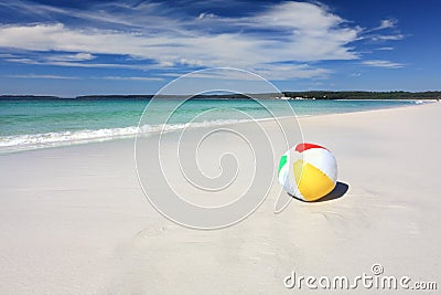 Colourful beach ball on the seashore by the ocean