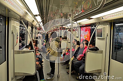 Commuters inside a Shanghai metro train railway carriage