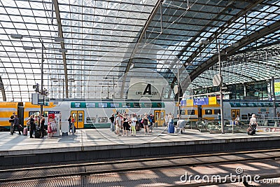 Commuters are waiting for the train at the central station of Berlin