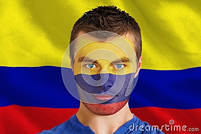 Composite image of serious young colombia fan with facepaint