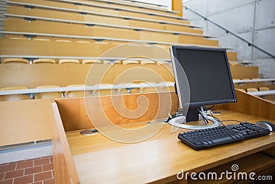 Computer monitor with empty seats in a lecture hall