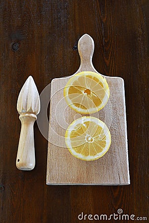 Concept with lemons and lemon squeezer